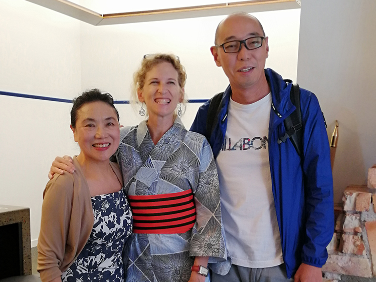 Two Japanese students with their English teacher in Auckland New Zealand, they have dressed their teacher in a kimono