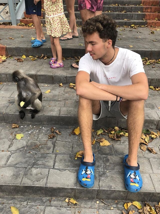 Ivan in Thailand sitting with a monkey